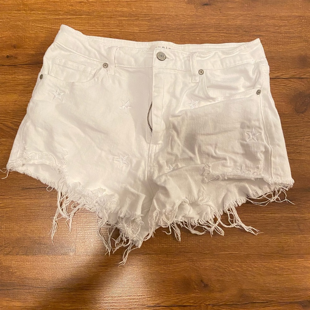 White denim embroidered star cut off shorts